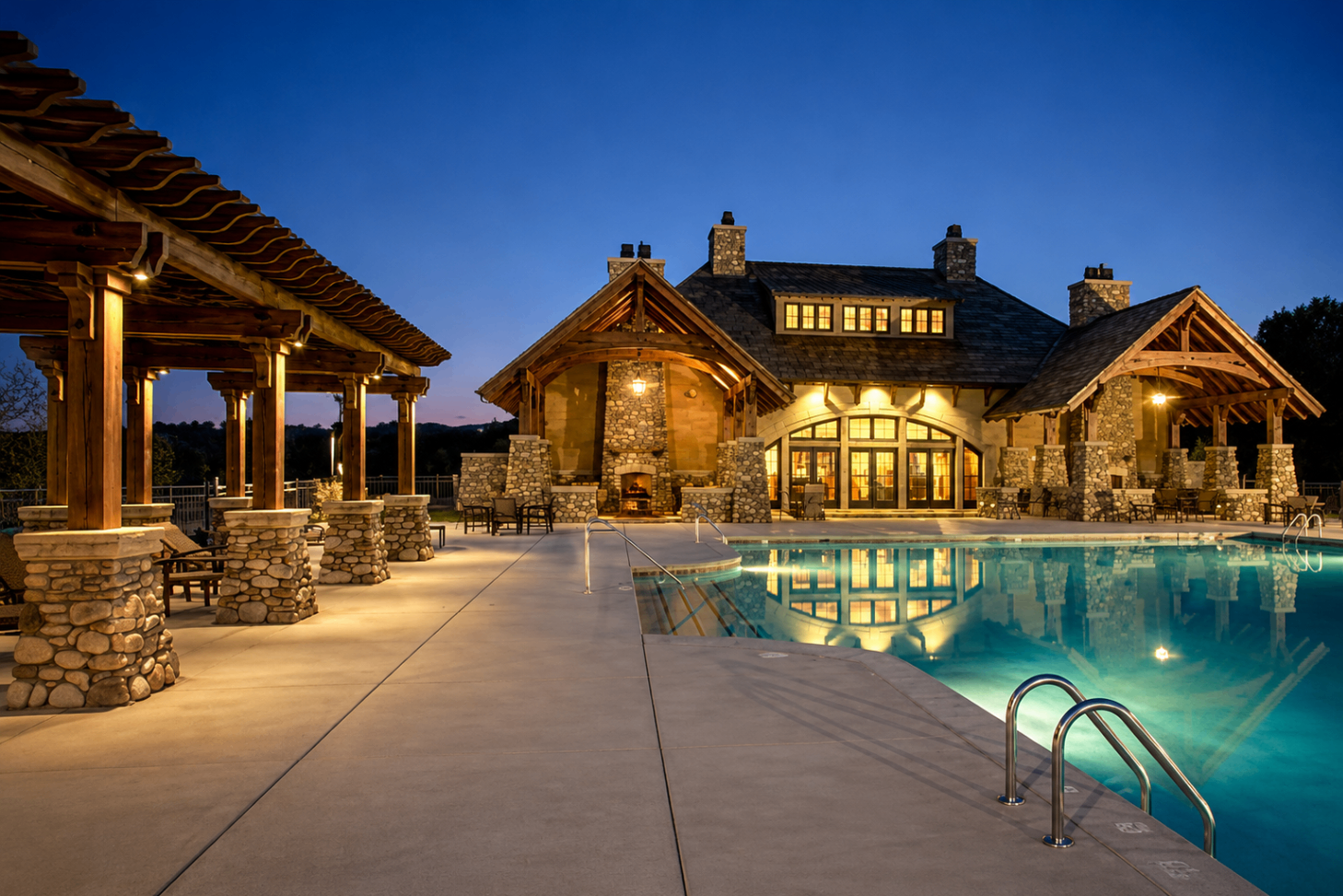Skyecroft clubhouse with pool, stone pavilions and pergolas at dusk